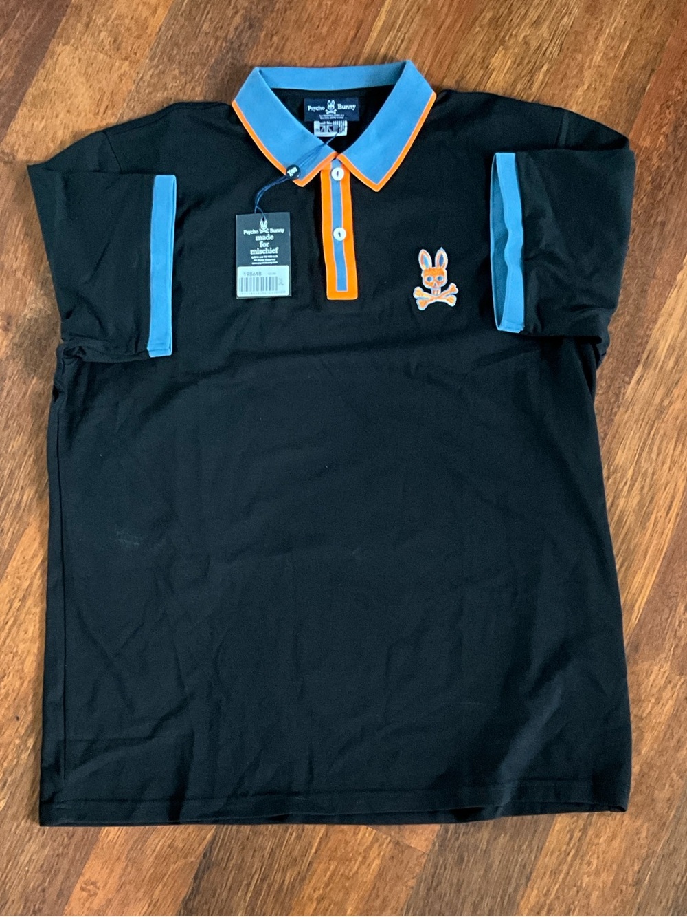 Psycho Bunny Black Polo with Sky Blue Sleeve Accents and Orange Collar Trim